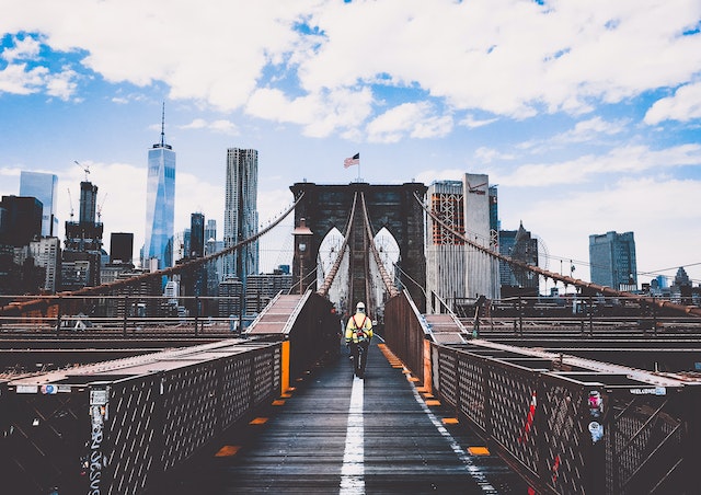 A man walking on the Brooklyn Bridge